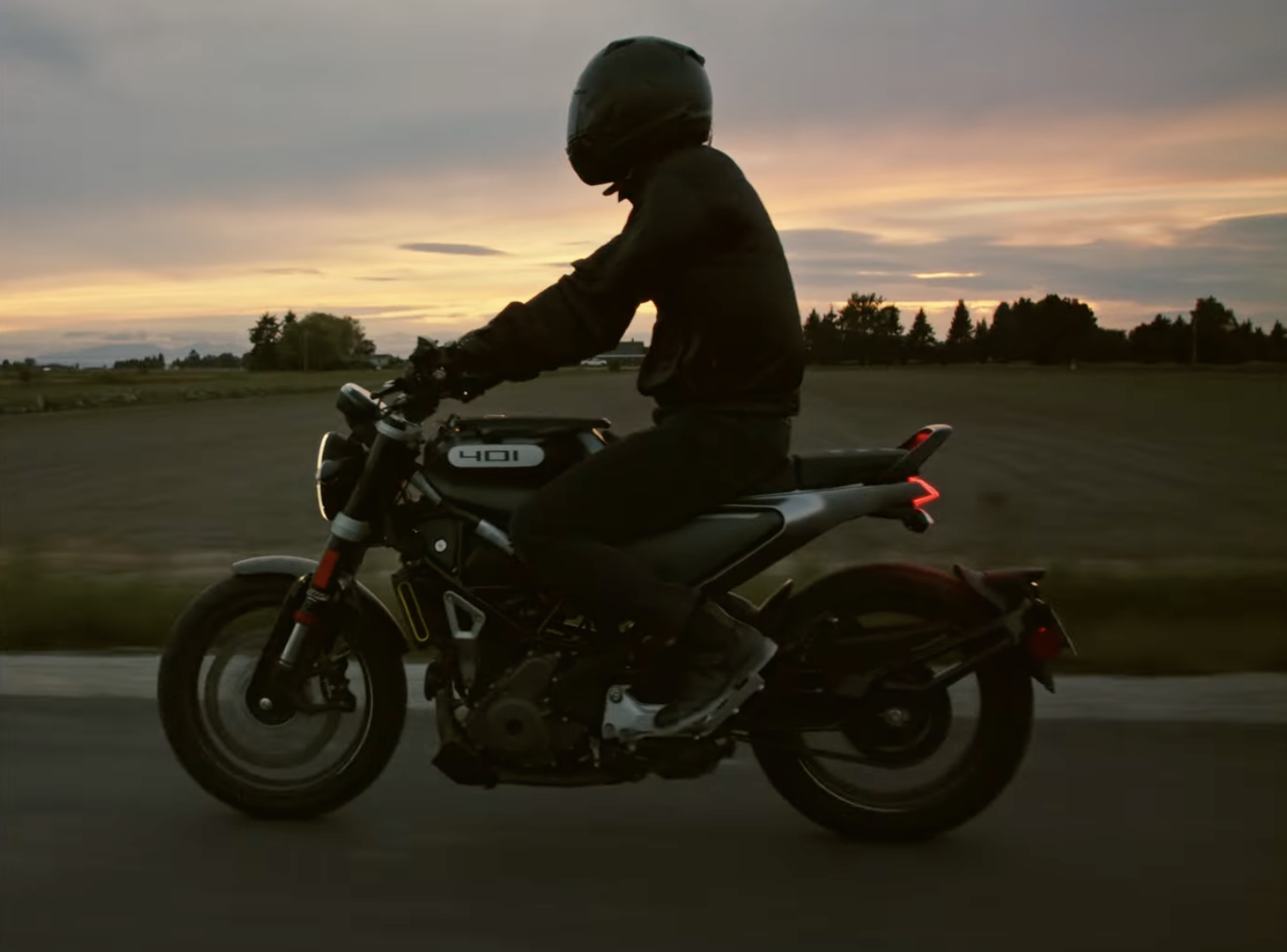 Person riding a motorcycle at dusk